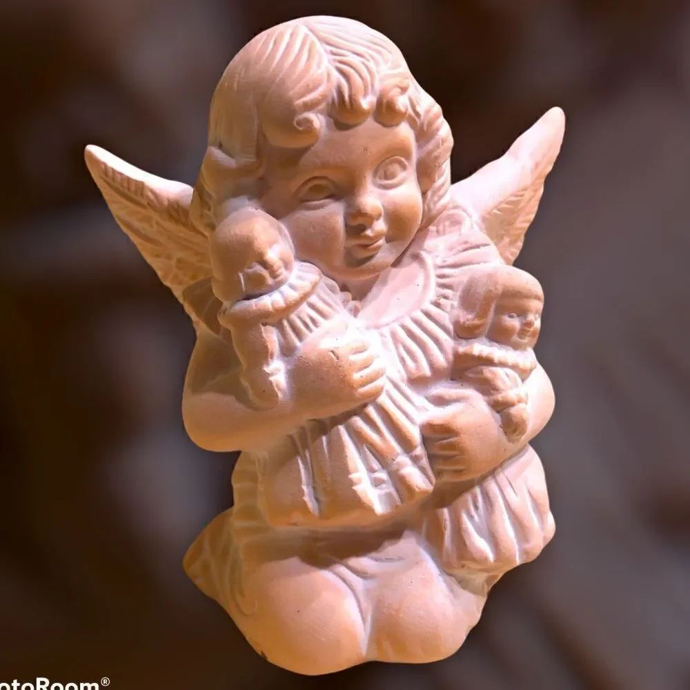 Vintage Cherub holding dolls miniature statue.